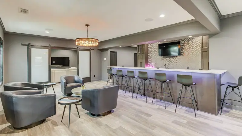 Finished basement with wet bar, lounge seating and recessed lighting